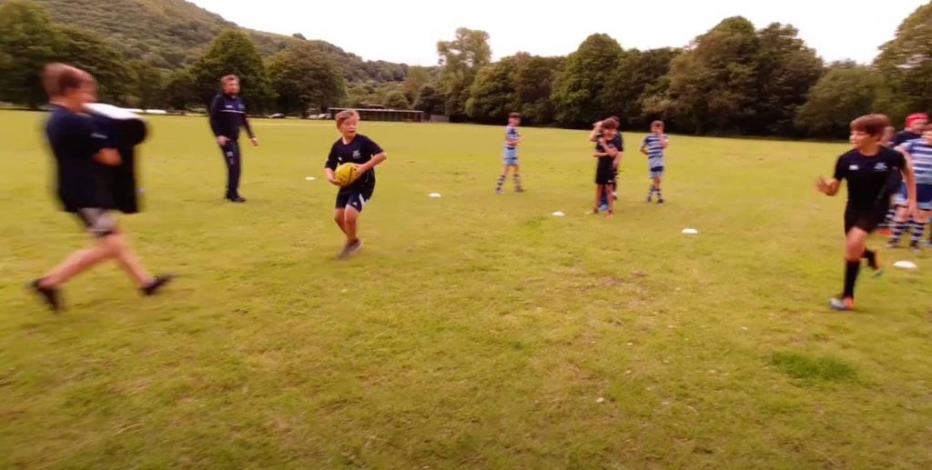 2 young junior rugby players practicing skills with Buzzball Rugby Training Ball